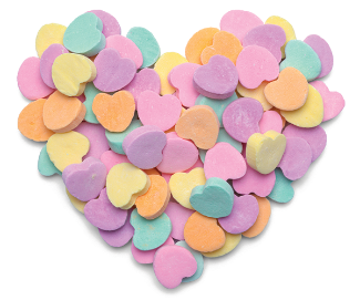 heart made of candy hearts in yellow, pink, purple, orange, and green