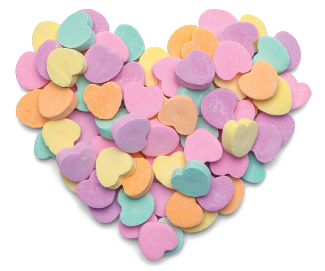 A heart shaped with candy hearts in the colors of yellow, green, orange, purple.